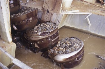 Bucket chain carries river bed gravel into the Ngahere Gold Dredge, West Coast, South Island, New