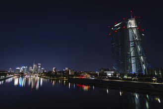 The lights of the European Central Bank (ECB) and the Frankfurt banking skyline are greatly reduced