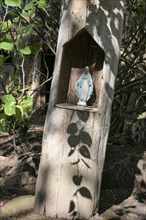 Madonna-Statue standing in a carved niche of a tree stump, Pantanal Wetlands, Mato Grosso, Brazil,