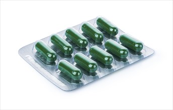 Blister of green capsules isolated on a white background