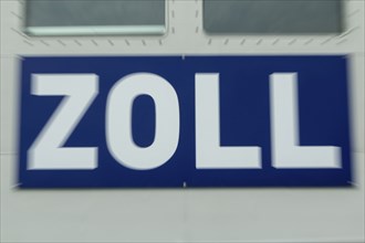 Close-up, sign with inscription customs at the customs boat Priwall in the harbour on the Priwall,