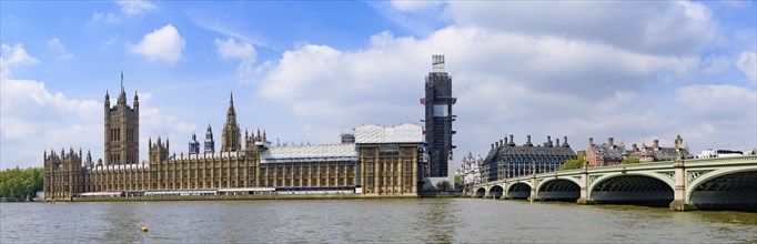 The Palace of Westminster as the Houses of Parliament on the north bank of the River Thames in