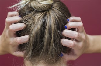 Great concept of allergy and skin diseases, young woman scratching her head