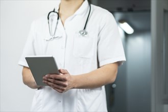 Close up of male doctor holding stethoscope in hospital. Medical concept with copy space