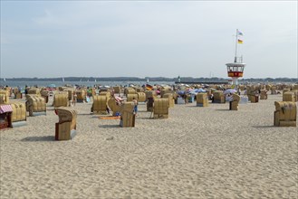 Summer weather, bathers, beach chairs and DLRG lifeguard tower on the beach, Travemünde beach,