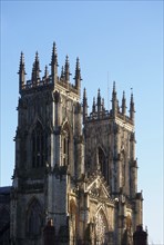 A view of the towers at the front of york minster in sunlight