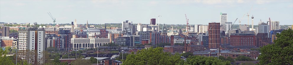 A wide panoramic view showing the whole of leeds city center with towers apartments roads and