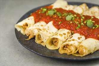 Brazilian pancakes with chicken, tomato bolognese sauce, rolled pancakes