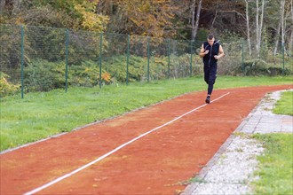 Young man jogging in the morning outdoor on the running race track