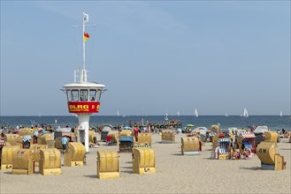 Summer weather, bathers, beach chairs and DLRG lifeguard tower on the beach, Travemünde beach,