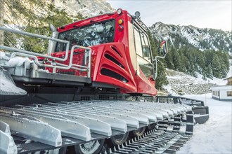 Close up image with a modern snow machine in an alpine decor, in the Austrian Alps, near the