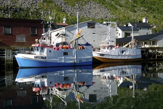 Fishing boats reflected in the Gryllefjord, Senja, Troms, Norway, Europe