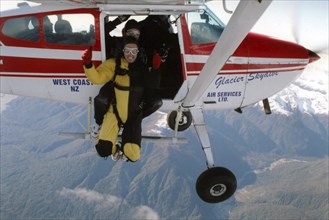 Greymouth, New Zealand, circa 2006: Two people about to drop out of plane with parachutes, West