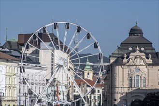 Bratislava Ferris wheel with reduta concert hall and TV tower in the distance