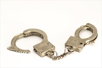 Pair of handcuffs close up front view on a white background