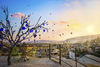 Dry tree with nazars amulets in Cappadocia at sunrise