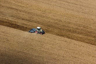 Tractor prepares a field for sowing. Agriculture