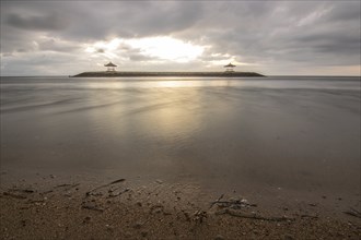 Beautiful seascape in the morning. Tropical sandy beach with breakwater and reflection of the sky