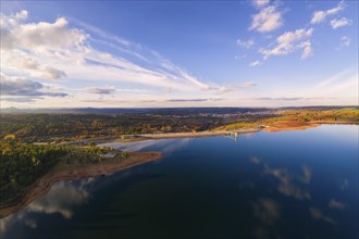 Drone aerial panoramic view of Sabugal Dam lake reservoir with perfect reflection, in Portugal