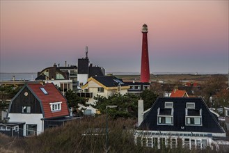 Huisduinen, the Netherlands. january 2022. Setting sun over the village and the lighttower.