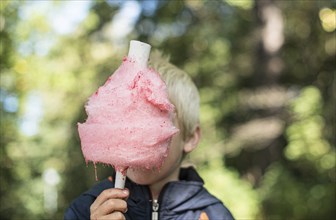 Pink candy floss in front of a kid