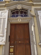 Old wooden door with decorative sign and lettering in a historic architectural style, Weissenburg,