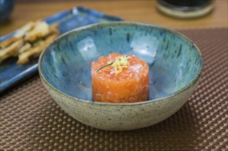 Salmon tartare deliciousness in a beautiful decorated plate