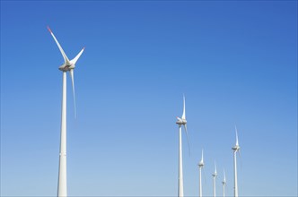 Great concept of renewable, sustainable energy. Wind field with wind turbines, producing aeolian