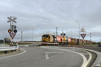 ARAHURA, NEW ZEALAND, AUGUST 29, 2020: A freight train crosses the main road at Arahura on State