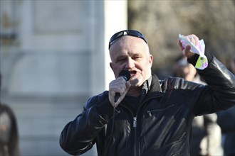 CHRISTCHURCH, NEW ZEALAND, JULY 24, 2021, A man speaks at a protest rally at the Bridge of