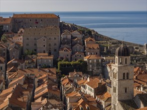 A medieval town with a church tower and red roofs by the sea, dubrovnik, Mediterranean, Croatia,