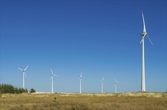 Great concept of renewable, sustainable energy. Wind field with wind turbines, producing aeolian