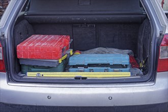 Boxes of work tools in car trunk