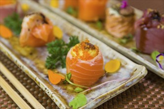 Platter decorated with different flavors of elegant sushi. Selective focus