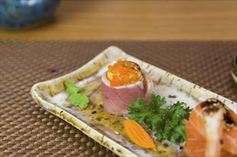 Platter decorated with different flavors of elegant sushi. Selective focus