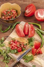 A close up view of cutting ingredient to make salsa