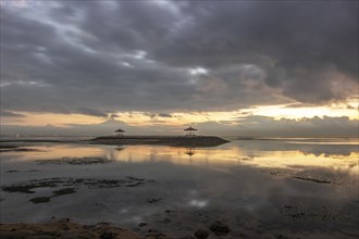 Beautiful seascape in the morning. Tropical sandy beach with breakwater and reflection of the sky