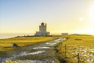 Famous lighthouse at sunset on Dyrholaey beach in Iceland in cold winter, near Vik