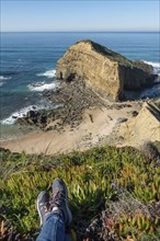 Woman feet at Praia dos Machados beach in Costa Vicentina, Portugal, Europe