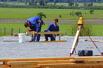 Builders mark out the profile for a building at a construction site in Westland, New Zealand,