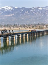 A train travels across the bridge that spans Lake Pend Oreille by Sandpoint, Idaho