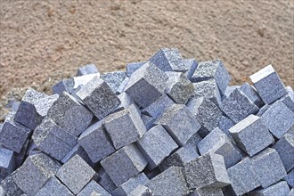 Big bunch of cobblestone bricks at construction site