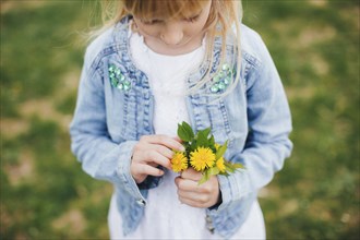 Small girl is holding Small girl is holding a bouquet with yellow flowers. a bouquet with yellow