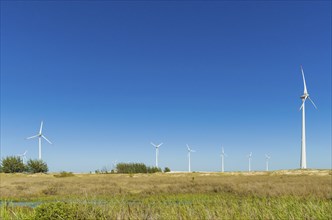 Great concept of renewable, sustainable energy. Wind field with wind turbines, producing aeolian