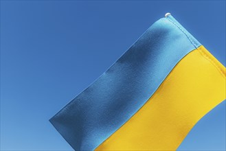 Large bicolor yellow blue Ukrainian state flag, national symbol fluttering, waving in wind against