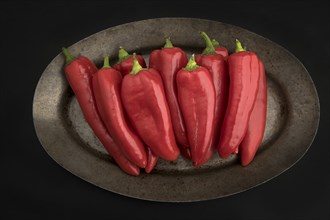 An overview of spicy red peppers stacked on a platter