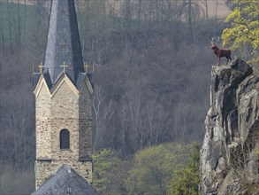 Church tower in Hirschberg an der Saale in Thuringia, the stag on the rock is the town's landmark