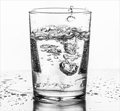 Water being poured into a glass. White background