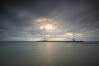 Beautiful seascape in the morning. Tropical sandy beach with breakwater and reflection of the sky