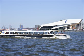 Amsterdam, Netherlands. April 2023. The river IJ with the Eye museum and a canalboat